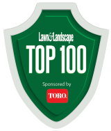 Green shield-shaped logo with the text "Lawn & Landscape TOP 100 Sponsored by Toro" in white and red.